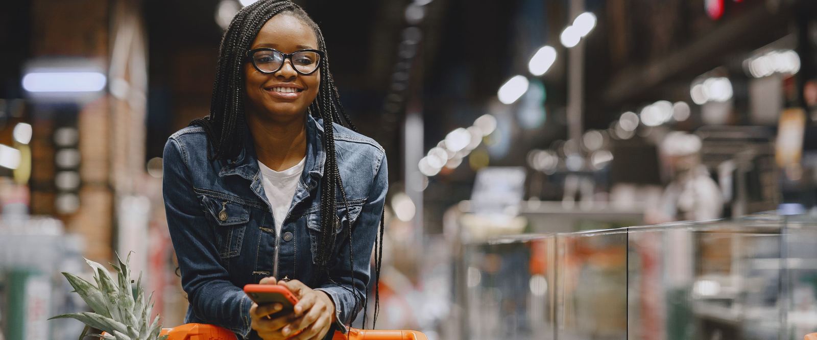 Shopper smiling at a personalised offer on her phone