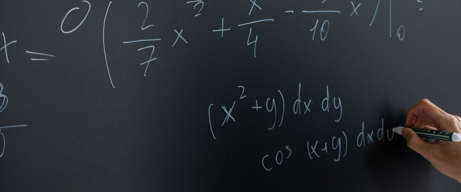 Mathematical equations being written on a blackboard